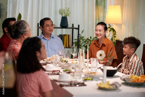 Happy Vietnamese married couple attending family dinner