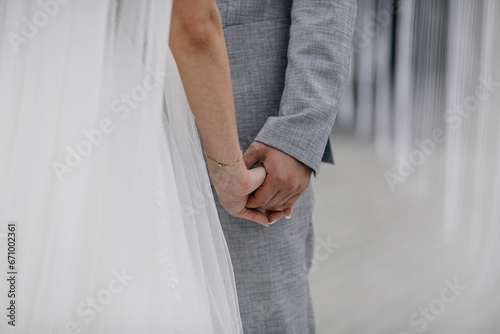 bride and groom holding hands