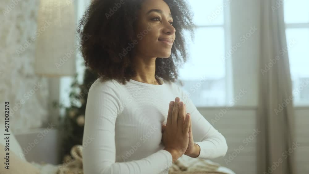 Relaxed young african american woman meditate and breathe slowly while make yoga at home Calm inspired curly female with closed eyes take break while resting for peaceful mind alone Relaxed young african american woman meditate and breathe slowly while make yoga at home Calm inspired curly female with closed eyes take break while resting for peaceful mind alone