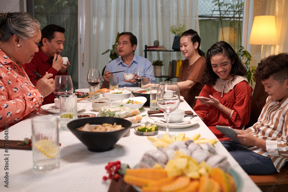 Big Asian family gathered together to have dinner and celebrate holiday