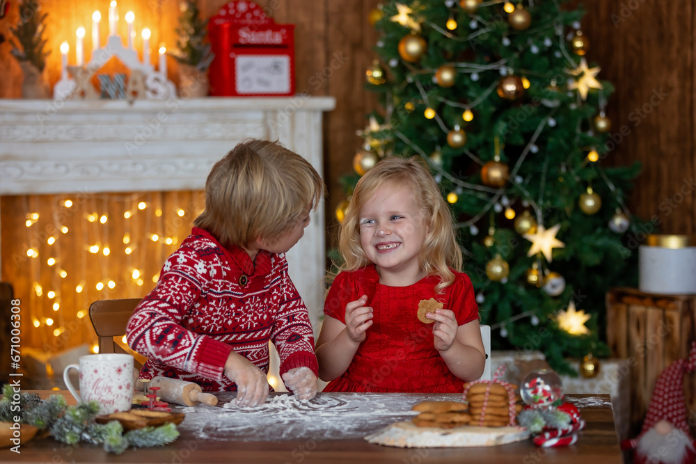 Beautiful children, blond kids, siblings, playing in decorated home for Christmas, enjoying holidays Beautiful children, blond kids, siblings, playing in decorated home for Christmas, enjoying holidays