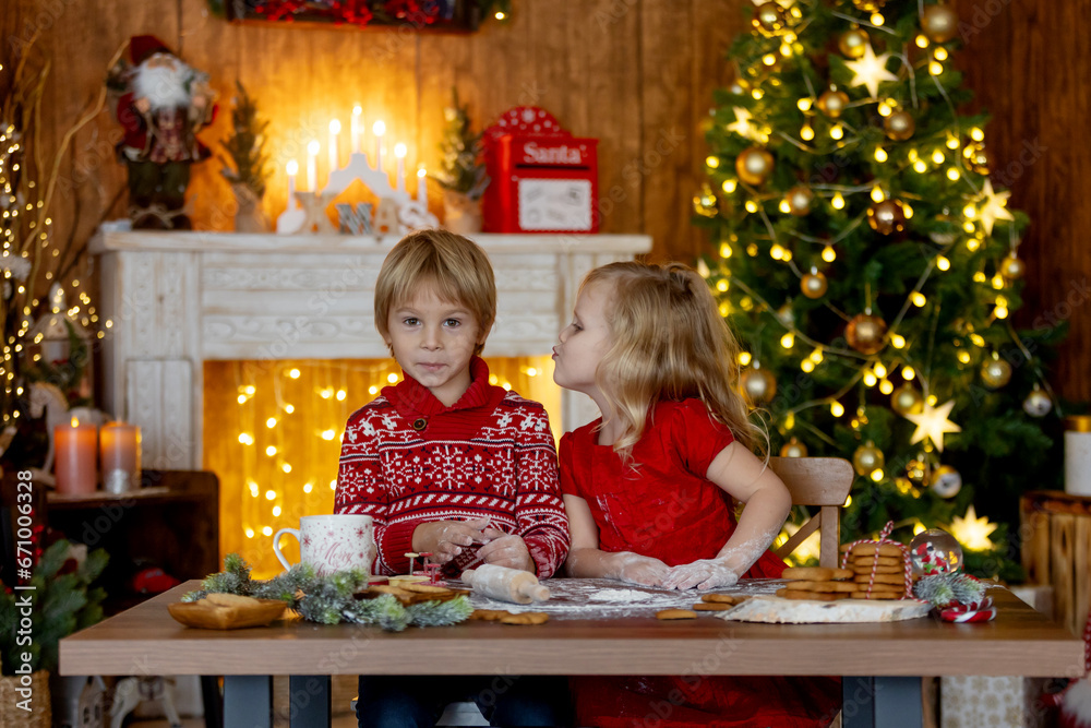 Beautiful children, blond kids, siblings, playing in decorated home for Christmas, enjoying holidays Beautiful children, blond kids, siblings, playing in decorated home for Christmas, enjoying holidays