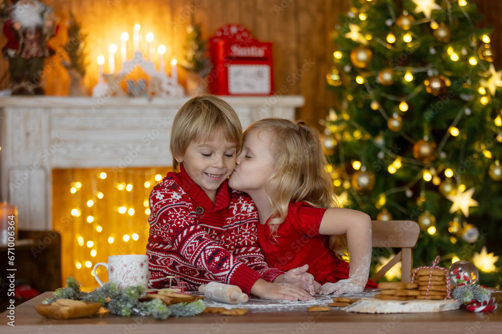 Beautiful children, blond kids, siblings, playing in decorated home for Christmas, enjoying holidays Beautiful children, blond kids, siblings, playing in decorated home for Christmas, enjoying holidays