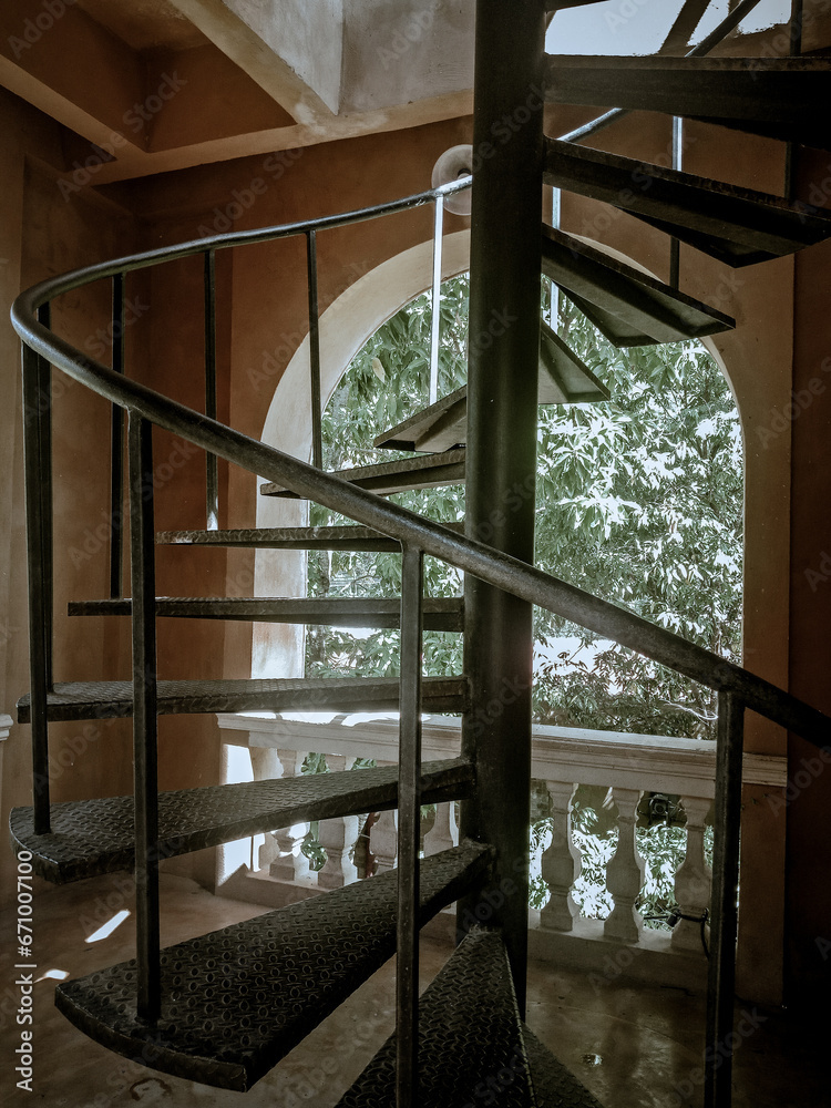 Looking at the spiral staircase, one feels drawn into its mesmerizing design. Looking at the spiral staircase, one feels drawn into its mesmerizing design.