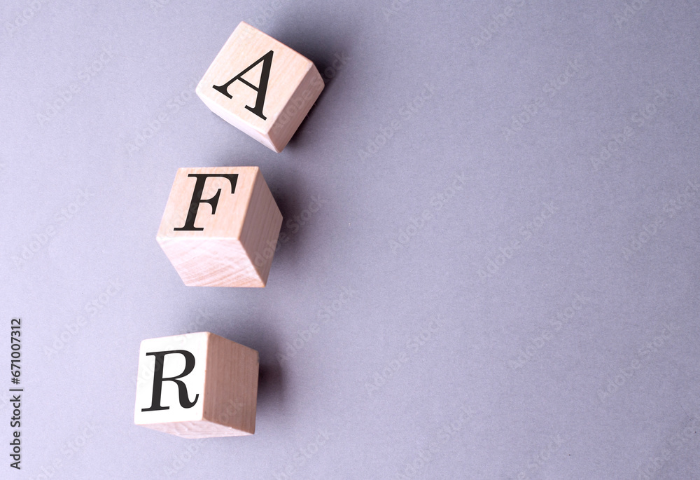 Obraz premium Word AFR on wooden block on the grey background