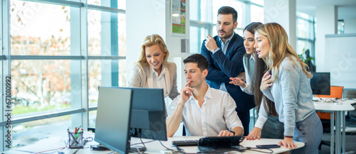 Business Team gathered in the office around computer focused on business planning, strategy, and goal-setting, discussing, nurturing creativity, fostering innovation, and generating new ideas.