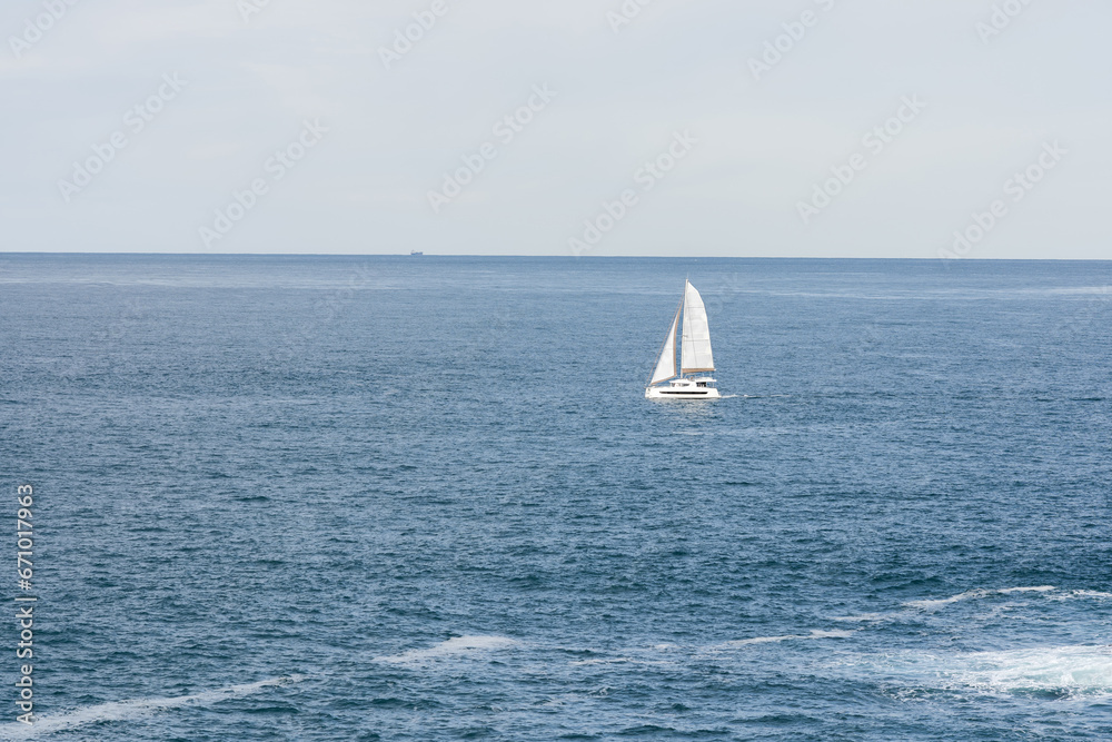 Sailboat on opened sea. Sailing at windy day.