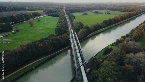 Regional train crossing a river bridge , agricultural fields in Europe Germany, aerial footage	 photo