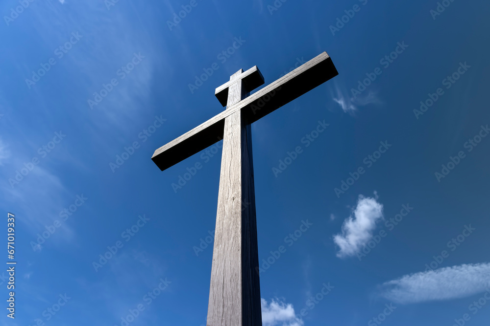 wooden christian cross on a blue sky background