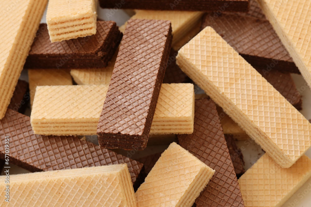 Stacked delicious chocolate wafers in large amount. Two different flavours of classic small waffles Stacked delicious chocolate wafers in large amount. Two different flavours of classic small waffles