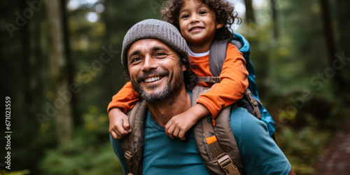Exploring Together: Father Carries Young Son Through Forest