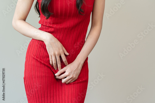 woman having painful lower stomach and hands holding pressing her crotch lower abdomen