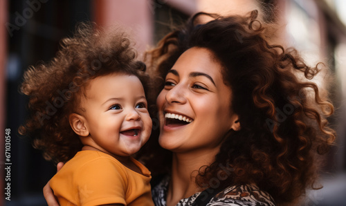 Blissful Moments: African-American Mom Kissing Baby Daughter