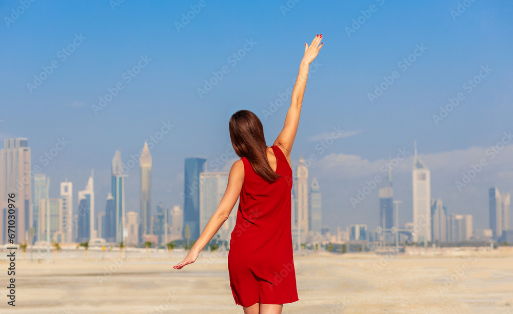 Dubai, UAE - tourist woman on beach and skyscrapers background