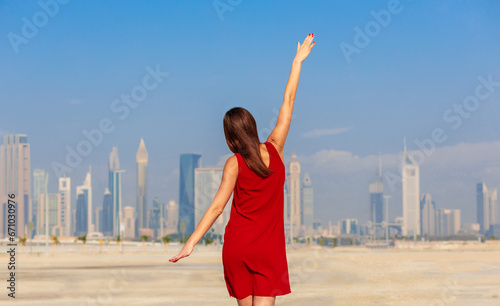 Obraz na płótnie Dubai, UAE - tourist woman on beach and skyscrapers background w salonie