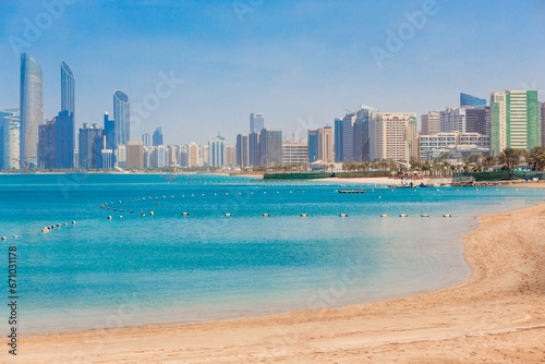 Cityscape Abu Dhabi with sea, beach and skyscrapers. Travel in UAE