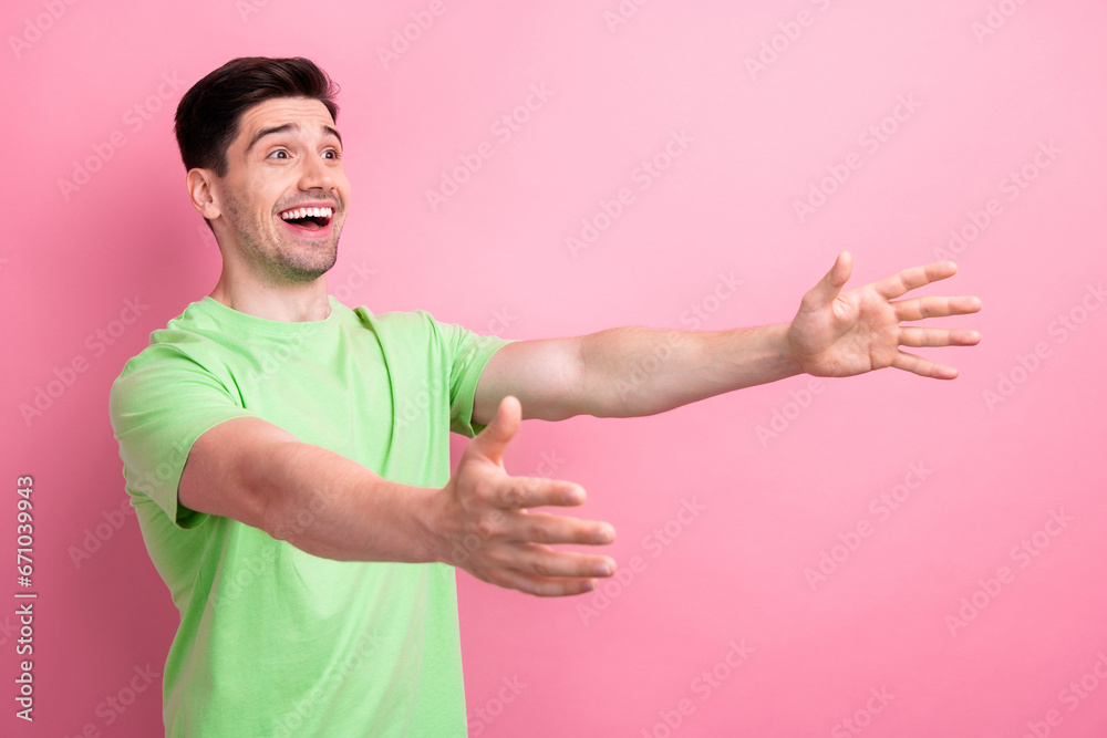 Photo of young excited attractive caucasian man wear green t shirt open hands to hug his friends isolated on pink color background