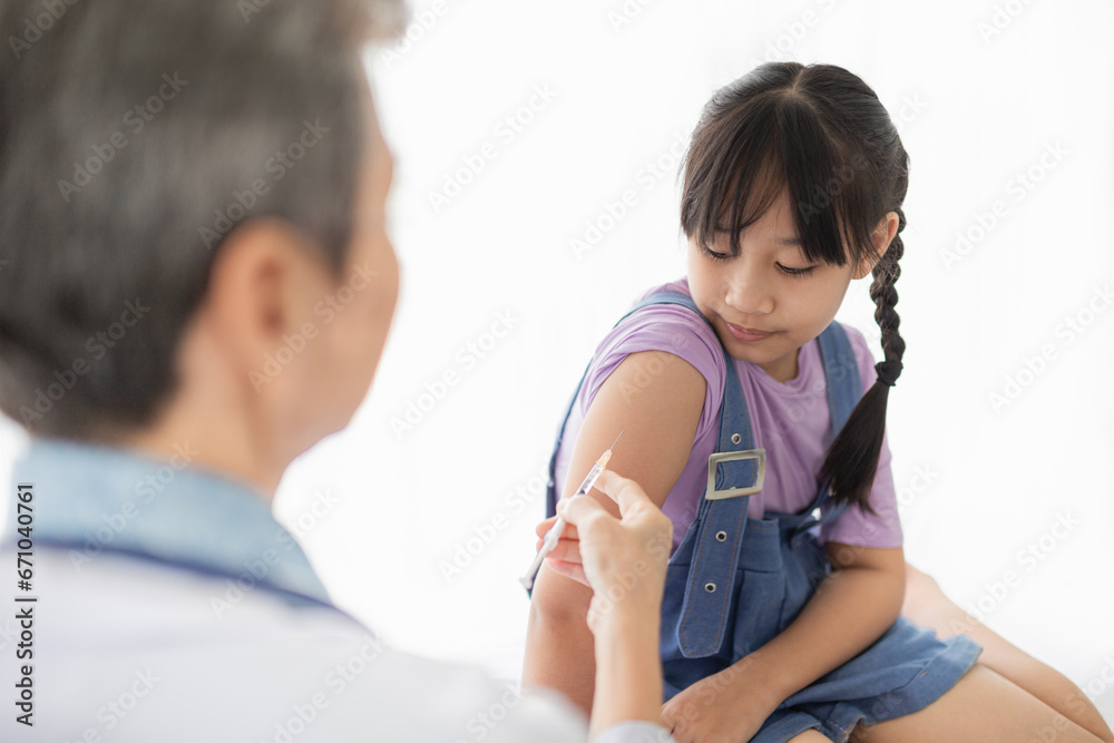 doctor inject vaccine to asian girl, Deltoid muscle injection technique, children immunization and health care promotion doctor inject vaccine to asian girl, Deltoid muscle injection technique, children immunization and health care promotion