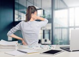 Beautiful young businesswoman suffering from back pain at work, AI generated image