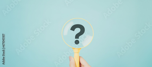 International ask a question day concept, Magnifying glass focused on question mark, Answer, Q&A, Communication and Brainstorming photo