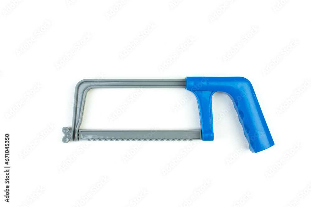 Hand saw, tool, children's toy on an isolated background. Copy space. Top view. Hand saw, tool, children's toy on an isolated background. Copy space. Top view.