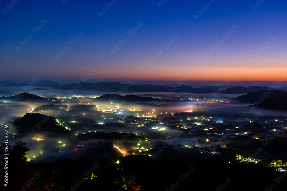 Scenic view of morning fog and mist against sky during sunrise