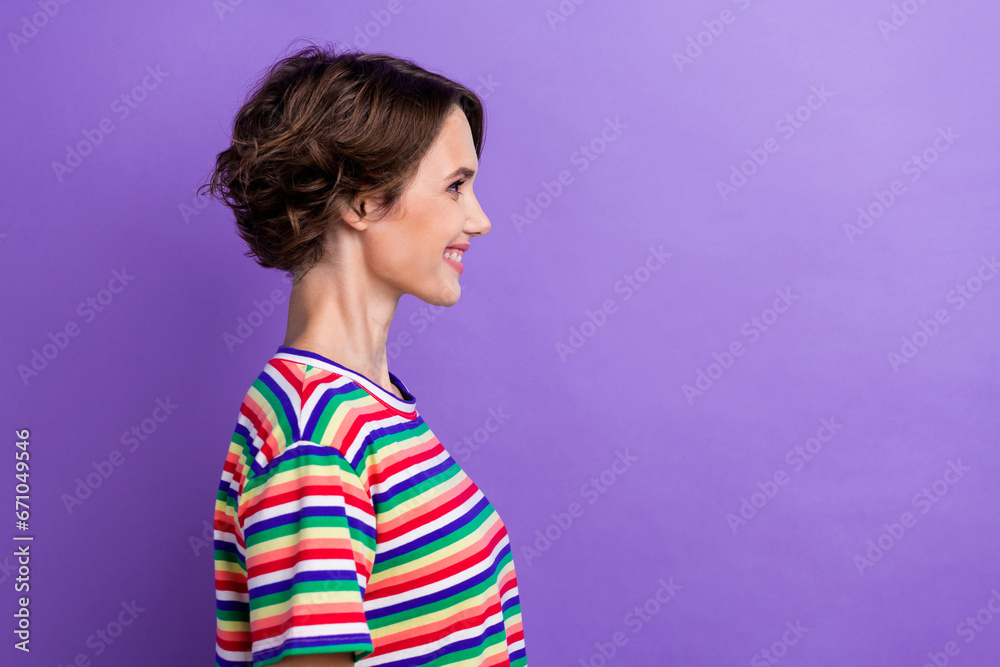 Profile photo of satisfied nice young lady toothy smile look empty space advert isolated on violet color background Profile photo of satisfied nice young lady toothy smile look empty space advert isolated on violet color background