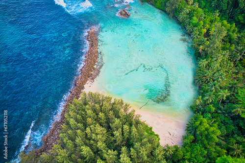 Bird eye drone of Port Glaud beach, granite stones, white sandy beach, turquoise water, coconut palm, greenery, trees, sunny day, Mahe Seychelles 2
