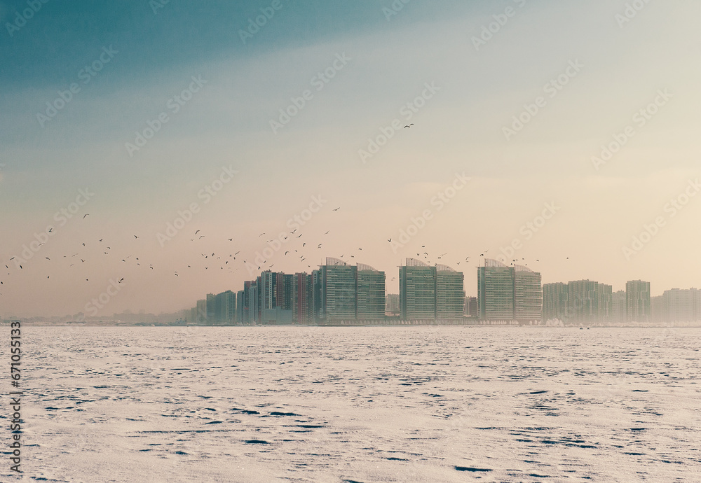 Winter landscape with snow covered frozen ice and city Winter landscape with snow covered frozen ice and city