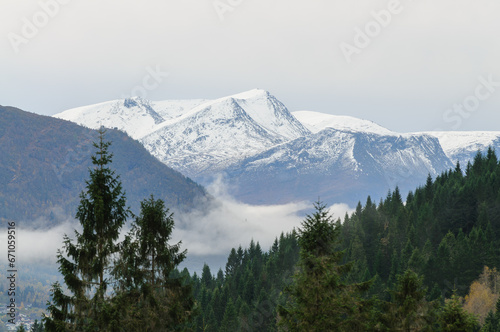 snow-capped mountain peaks above mist-covered valleys