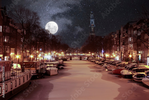Snowy Amsterdam by night in the Netherlands