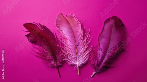  three pink feathers on a pink surface with a pink background.  generative ai © Nadia