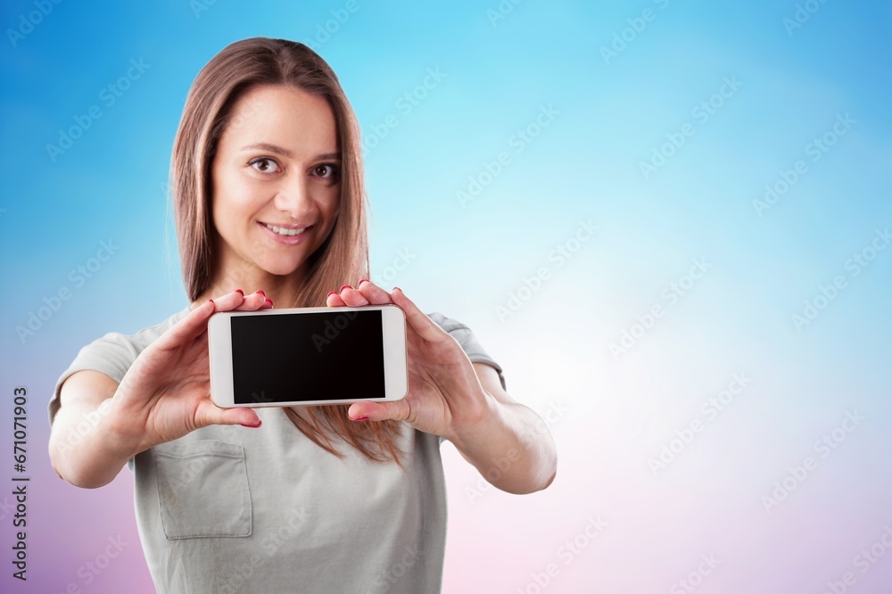 Beautiful young woman hold smartphone with blank screen