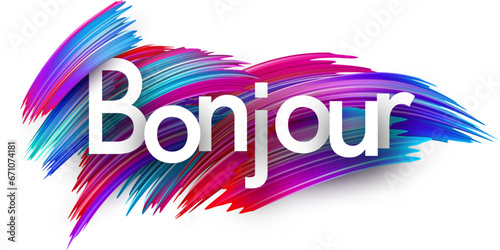 Hello at French paper word sign with colorful spectrum paint brush strokes over white.