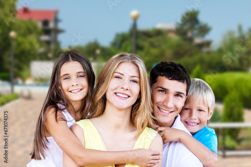 Happy young family in the city garden