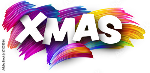Xmas paper word sign with colorful spectrum paint brush strokes over white.