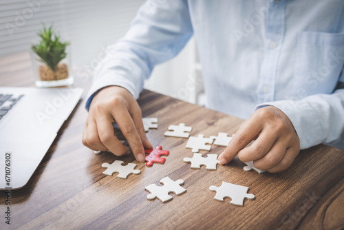 person hand connecting jigsaw puzzle pieces, business solutions, goals, success, goals and strategy concept, teamwork concept.