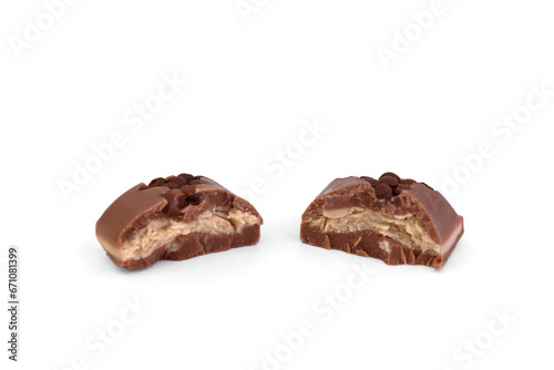 Broken piece of milk chocolate with hazelnut filling isolated on white background.