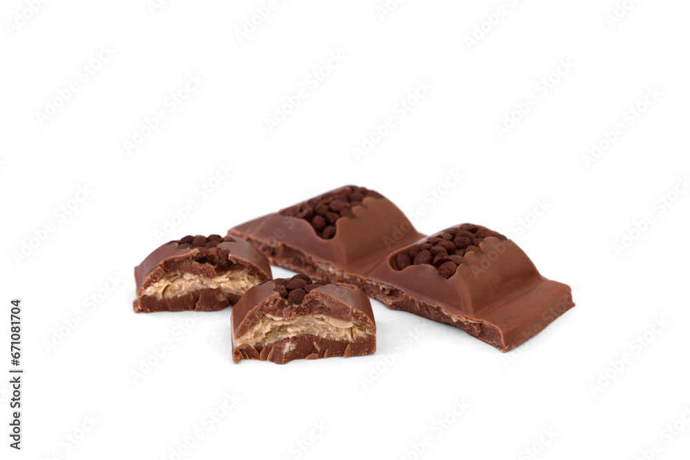 Broken pieces of milk chocolate with filling isolated on white background. Broken pieces of milk chocolate with filling isolated on white background.