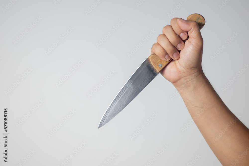 Obraz premium Male hand holding a knife on white background