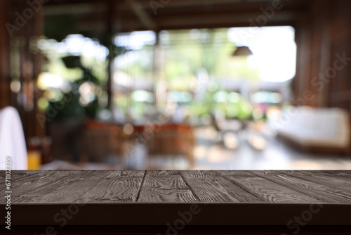 Empty wooden table in cafe  blurred interior. Space for design