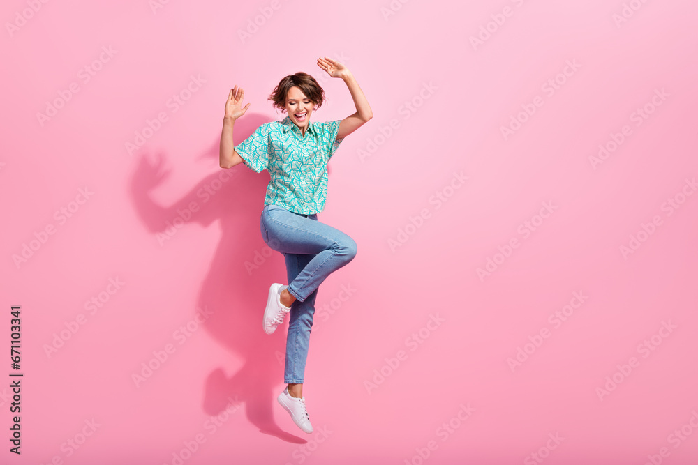 Full body portrait of overjoyed energetic lady jumping good mood empty space isolated on pink color background