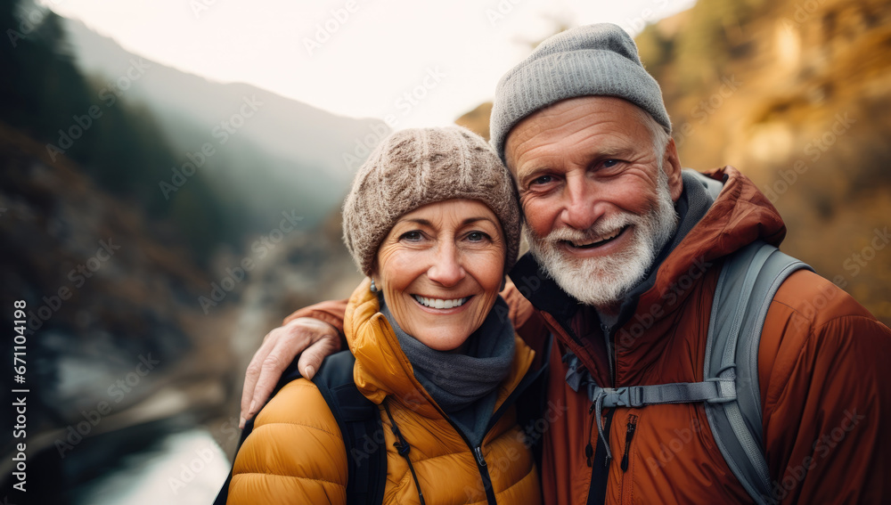 Romantic married retired senior couple hiking in the mountain
