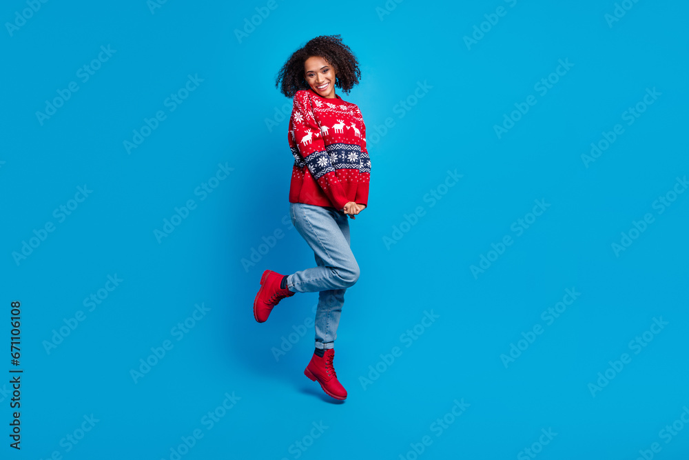 Photo of positive funky girl wear stylish ornament sweater new year party magic holly jolly empty space isolated on blue color background