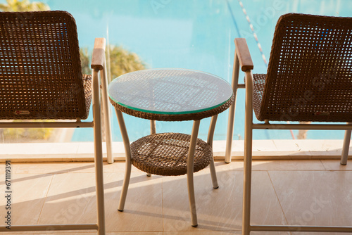 Outdoor furniture next to poolside. Summer relaxation and vacation vibes