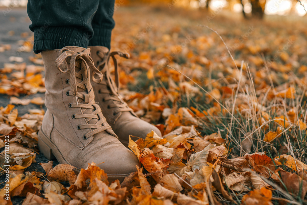 A man walks along an autumn road, boots close-up A man walks along an autumn road, boots close-up
