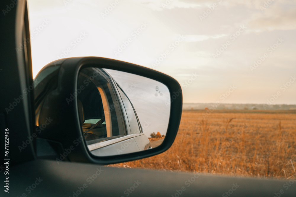 Autumn view from the side mirror of a car