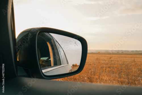 Autumn view from the side mirror of a car © shine.graphics