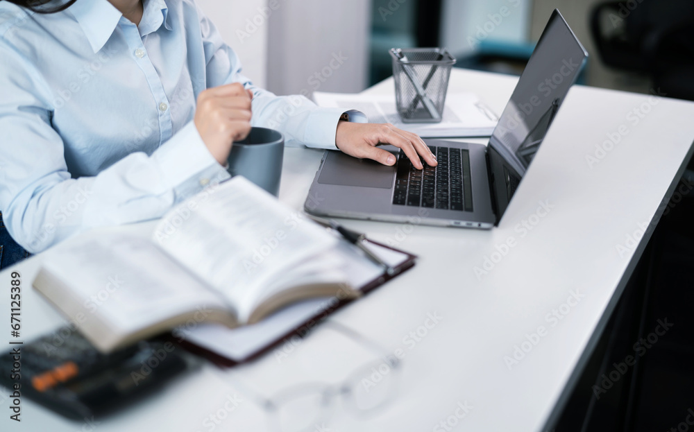 Asian Woman working by using a laptop computer Hands typing on Asian Woman working by using a laptop computer Hands typing on