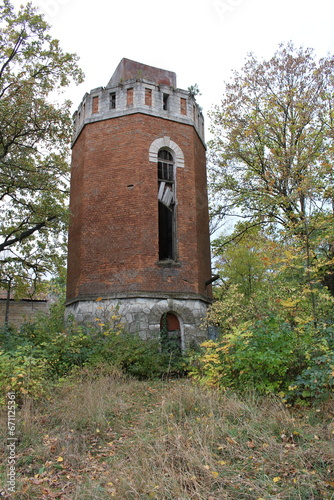 A brick tower with a broken window